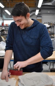 Undergraduate student Rafael Moreno designs his pottery plate at the pottery workshop event. Photo by Aliyah Navarro- Photojournalist