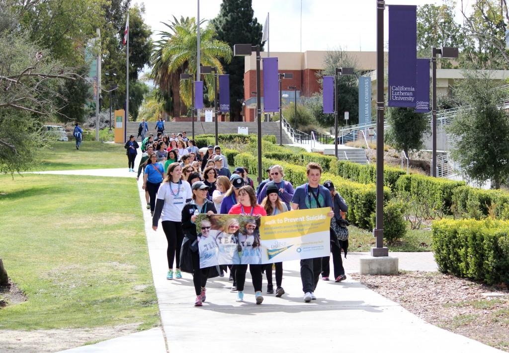 Light in the darkness: Out of the Darkness participants walk to raise suicide prevention awareness and chant “#stopsuicide” as they walk through the Cal Lutheran campus and surrounding neighborhood. Photo by Rachel Holroyd- Photojournalist