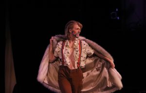 My beard glitters: Junior Ruth Smitherman, also known as drag king “Babe Ruth,” does a dance performance with two fellow student drag kings Friday night in the Preus-Brandt Forum in the show put on by Pride Club. Photo by Arianna Macaluso- Photojournalist