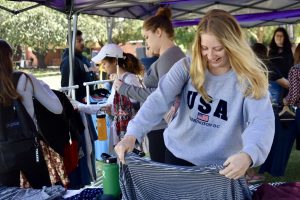 Get in, loser, we’re going thrift shopping: Sam Meyer picks out free clothes at the clothing swap hosted by the Community Service Center celebration of Green Week. Photo by Natalie Elliott- Photojournalist