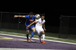 Senior forward Jared Pishke races a Sagehen defender for the ball.  Photo by Brooke Stanley - Sports Editor 