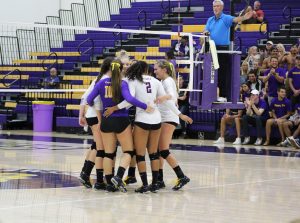The Regals celebrate a kill by junior right side hitter Amy McKee in the second set of the match.  Photo by Brooke Stanley- Photo Editor 