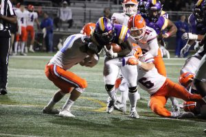 Senior running back Chris Anderson runs the ball 16 yards to score the game-winning touchdown with just 2:05 left on the clock.  Photo by Arianna Macaluso - Photo Editor