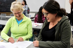 Speaking Spanish: Lifelong learner Pricilla Lee shares her thoughts on a Spanish assignment with undergraduate Karla Toledo. Photo by Christie Kurdys-Photojournalist.