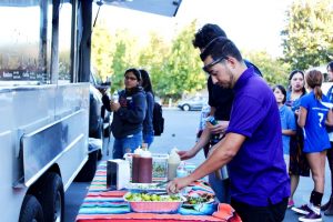 The first 200 people who attended the block party Oct. 15 were given raffle tickets to exchange for free food. Most students came directly after class for a free dinner. Photo by Christie Kurdys - Photojournalist
