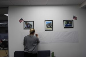 Beneath the photos: The Veterans Affairs office established a memorial wall outside of their office in the Student Union to commemorate Justin Meek.