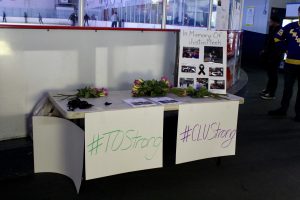  #CLUStrong:  Photos of Justin Meek were displayed at the entrance of the rink, along with posters for friends and family would write down memories of Meek.  Photo by Brooke Stanley - Sports Editor