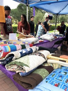 Quilted with care: Over 170 hand-made blankets, quilts and shawls were sent to Cal Lutheran from across the country to show support for the campus. They will be distributed again Dec. 4 and 5.  Photo provided by Jordan Castro. 