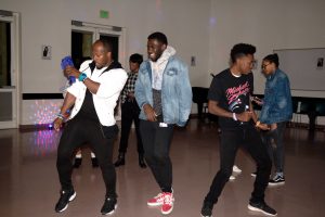 From left to right, Kevin Capel, Rob Hunter, and Chris Brodnax dance to ‘90s jams at Sisters’ Circle’s benefit party. The $3 entrance fee went to the Black Youth Project.  Photo by Katie May- Photojournalist. 