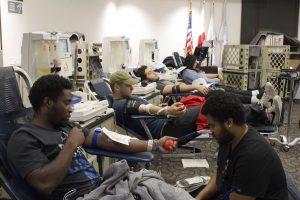 Hasant Moses-Hillman, Matthew Butler and Gianluca Vanni donate blood Feb. 13 at the blood drive. Butler said he has donated blood nearly 10 times in his life. Photo by Jessica Colby - Photojournalist