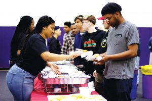 Soul Fest attendees dish up food including varieties of fried chicken, green beans, biscuits and miniature pies.  Photo by Gabby Flores- photojournalist. 