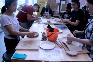 Students begin building clay models of their banquet plates at the first pottery station set up in the William Rolland Art Center ceramics room. Photo by Joc Smith - Photojournalist