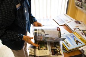 Anita Londgren flips through publications that the Scandinavian Cultural Center has been featured in. The center is not officially a part of Cal Lutheran, but works with the university and puts on the annual Scandinavian Festival in Kingsmen Park.  Photo by Katie May- Photojournalist. 