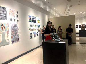 Senior Hallie Maxwell discusses her art at a walk-through of “Natural Conditions,” an exhibit assembled by the art capstone class, on May 3.  Photo by Lindsey Potter- Reporter. 
