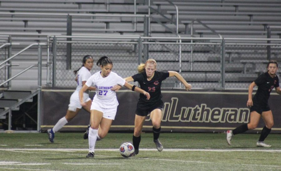 First-year forward Isabella Veljacic goes after the ball against Chapman senior defender Faith Holloway during the SCIAC semifinal game on Thursday, Nov. 7.
