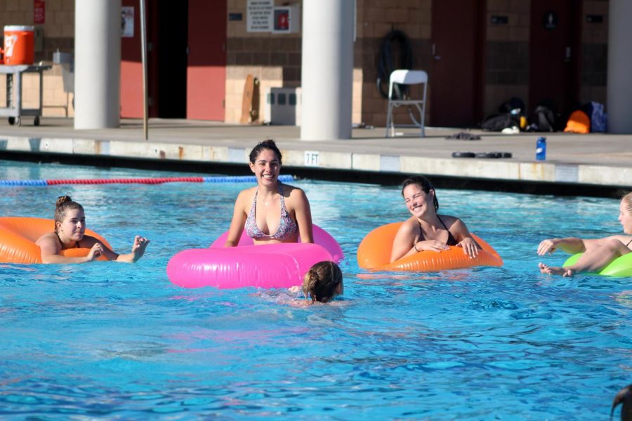 Senior+Morgan+Snyder+%28left%29+laughs+with+her+team+as+they+watch+other+participants+get+ready+to+shoot+at+intramural+sport%E2%80%99s+innertube+water+polo+tournament.