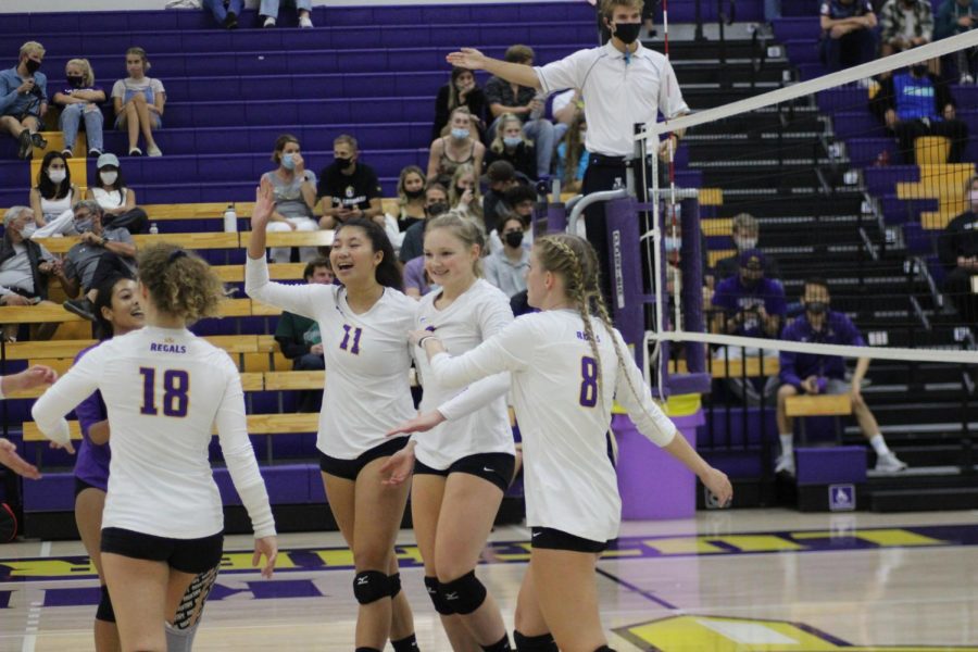 The Regals celebrate after scoring a point against Occidental (Photo by Karly Kiefer-Reporter)