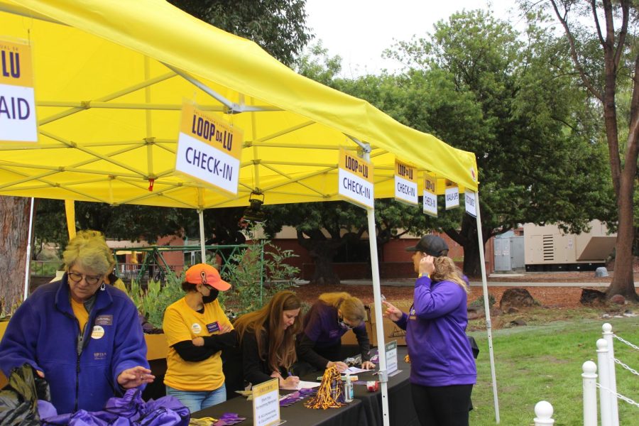 Volunteers help at the sign up table to get runners registered and hand out cool Cal Lutheran merchandise.