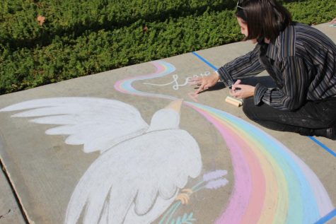 PRIDE Club President Alaina Murphy creates the beginning of her mural inspired by PRIDE (People Respecting Individuality, Diversity, and Equality).