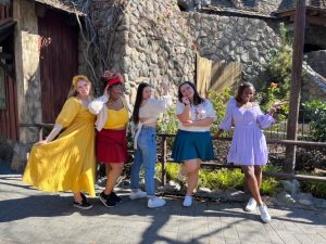 Five Cal Lutheran students pose as Encanto characters at Disneyland.