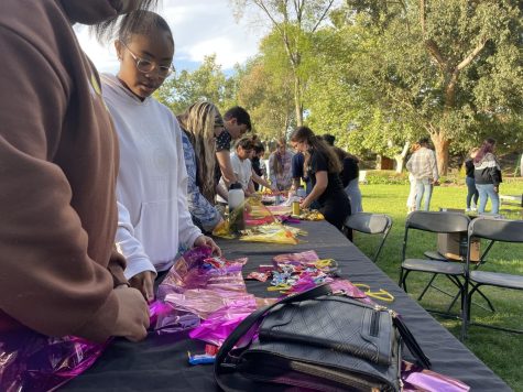 Students create candy leis at CCEI Night Market event held at Kingsmen Park on Apr. 4.