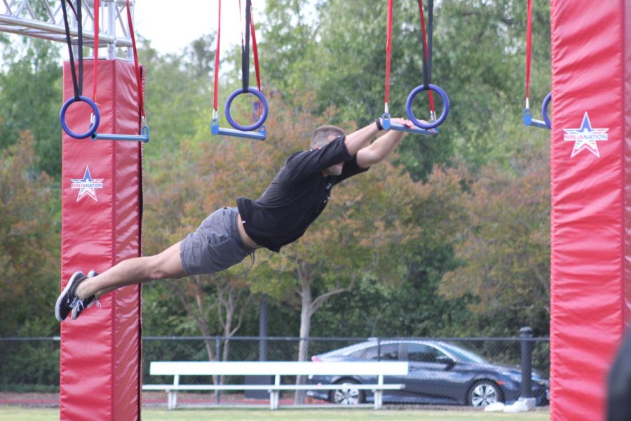 Nathan Sellers leaps between hanging bars on the Ninja Nation obstacle course. 