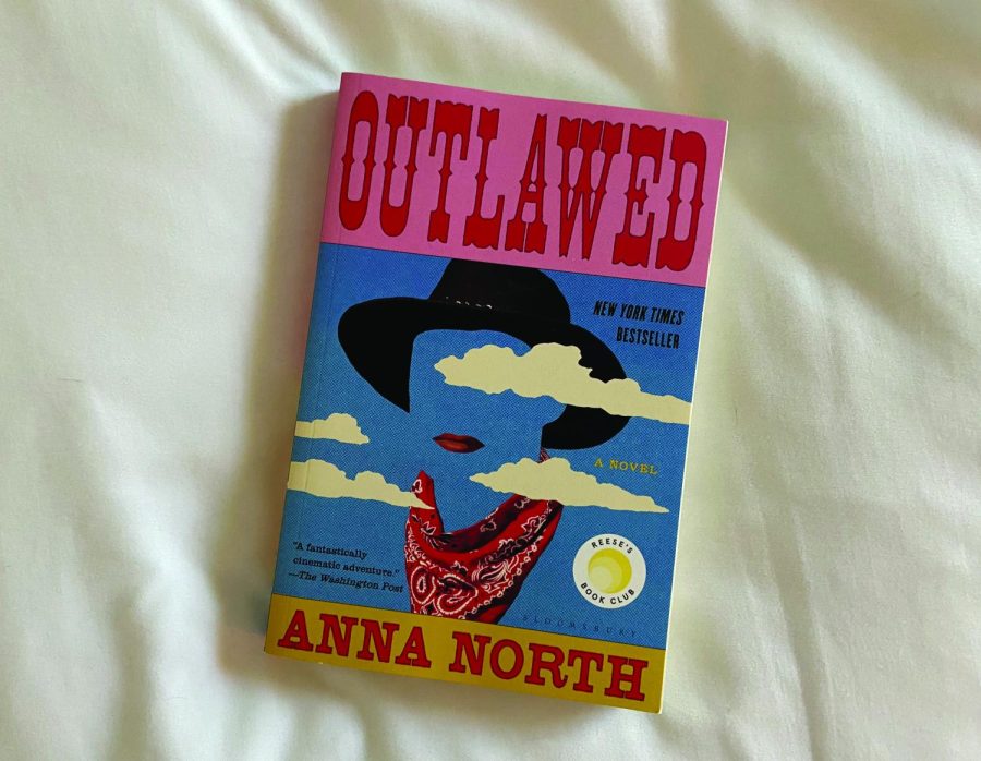 Outlawed+by+Anna+North+on+white+bed+sheet
