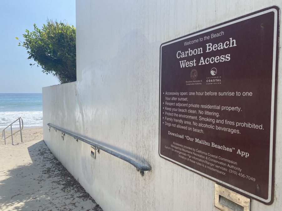 Carbon Beach sign on wall next to ocean