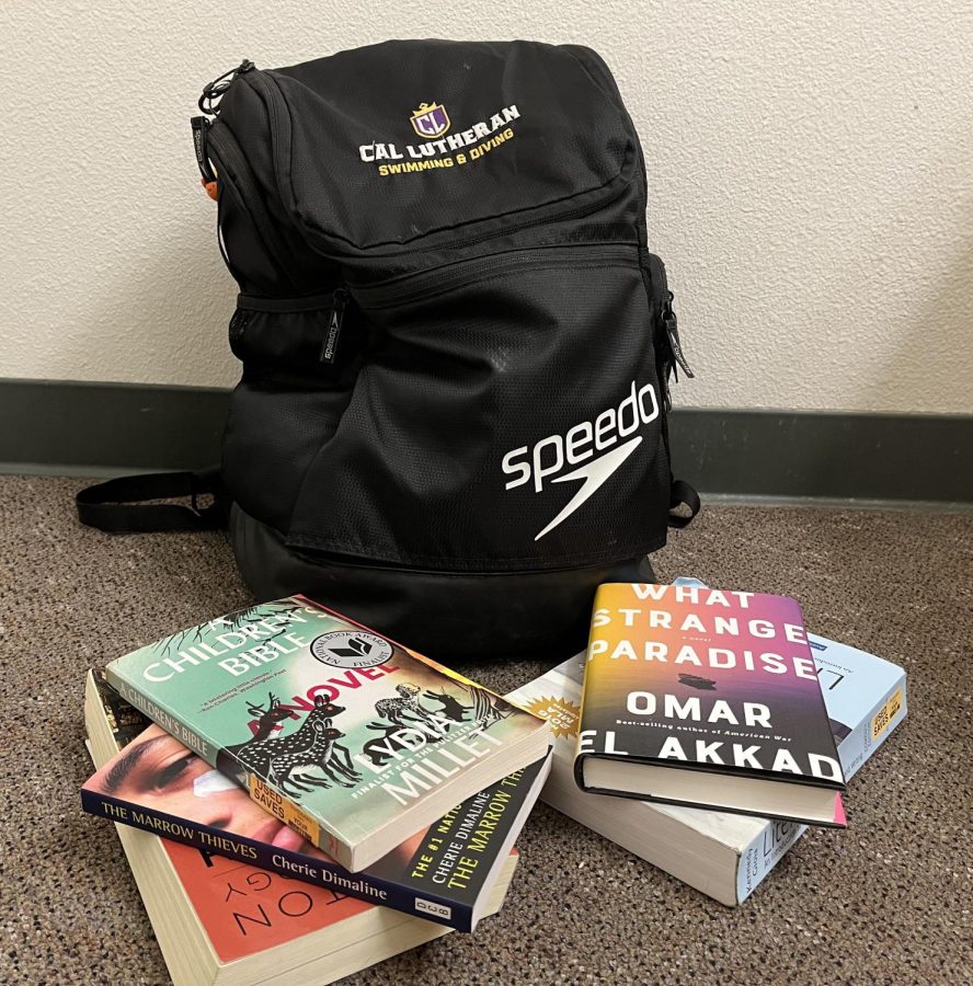 A+sports+backpack+is+surrounded+by+books.