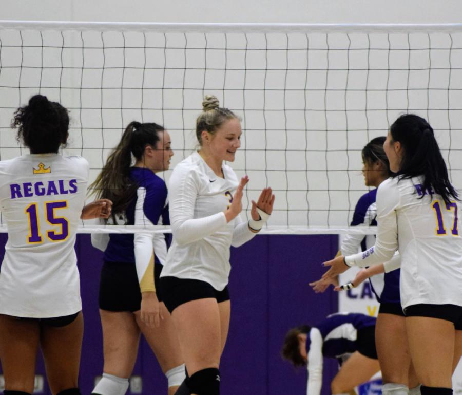 Maci+Haddad+high+fives+her+teammates+during+a+Regals+volleyball+game+at+Gilbert+Arena.