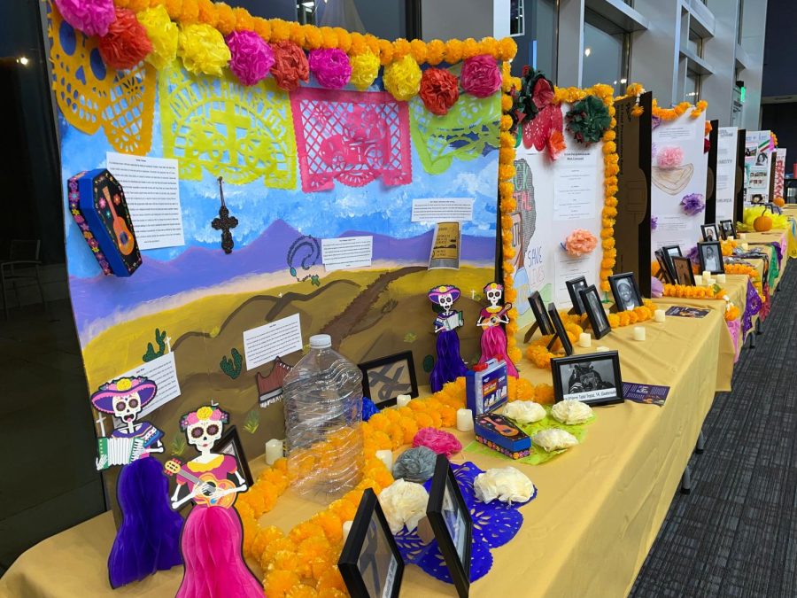 The social justice alters feature marigolds, papel picados and photos that display those who are deceased. The candles provide a lit path to guide the spirits of those honored home. 