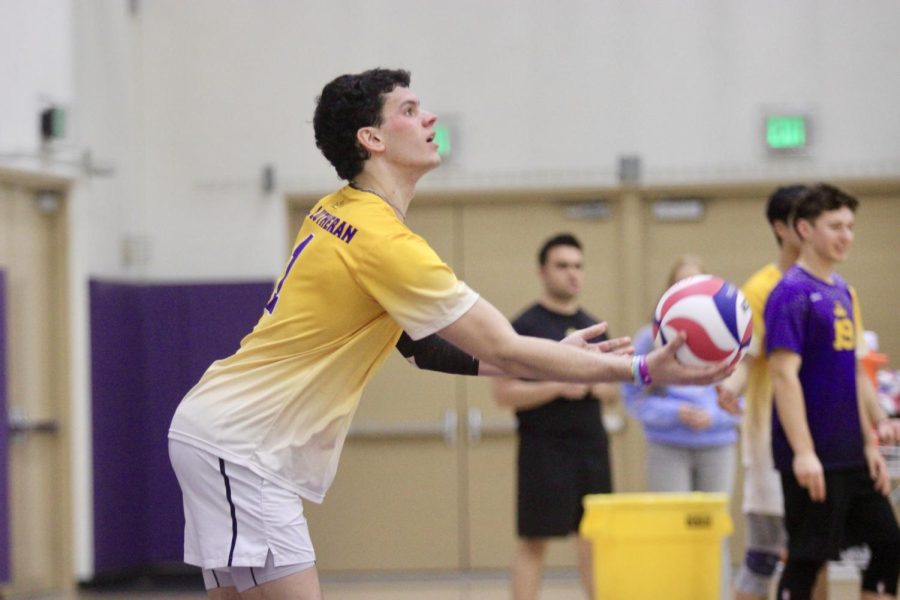 A member of the Kingsmen volleyball team prepares to serve the ball.