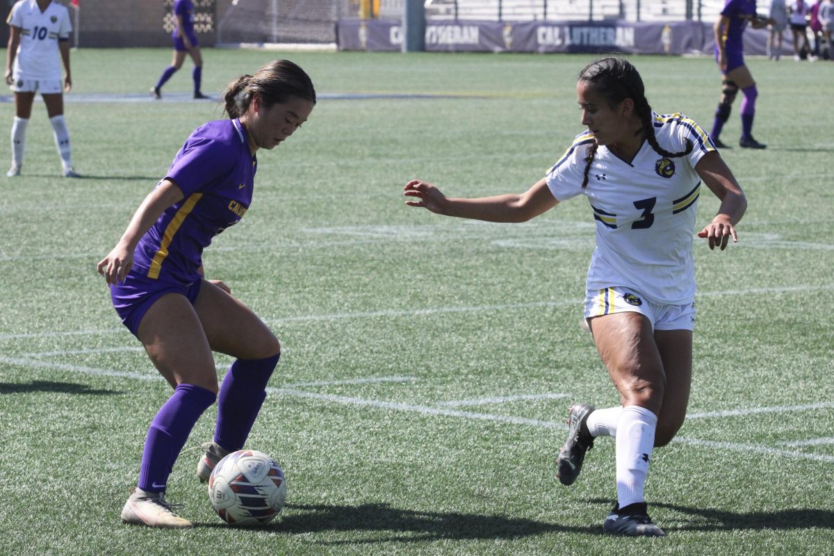 Junior forward Ryan Kaneko defends possession of the ball during Sunday's game against the University of California Santa Cruz.