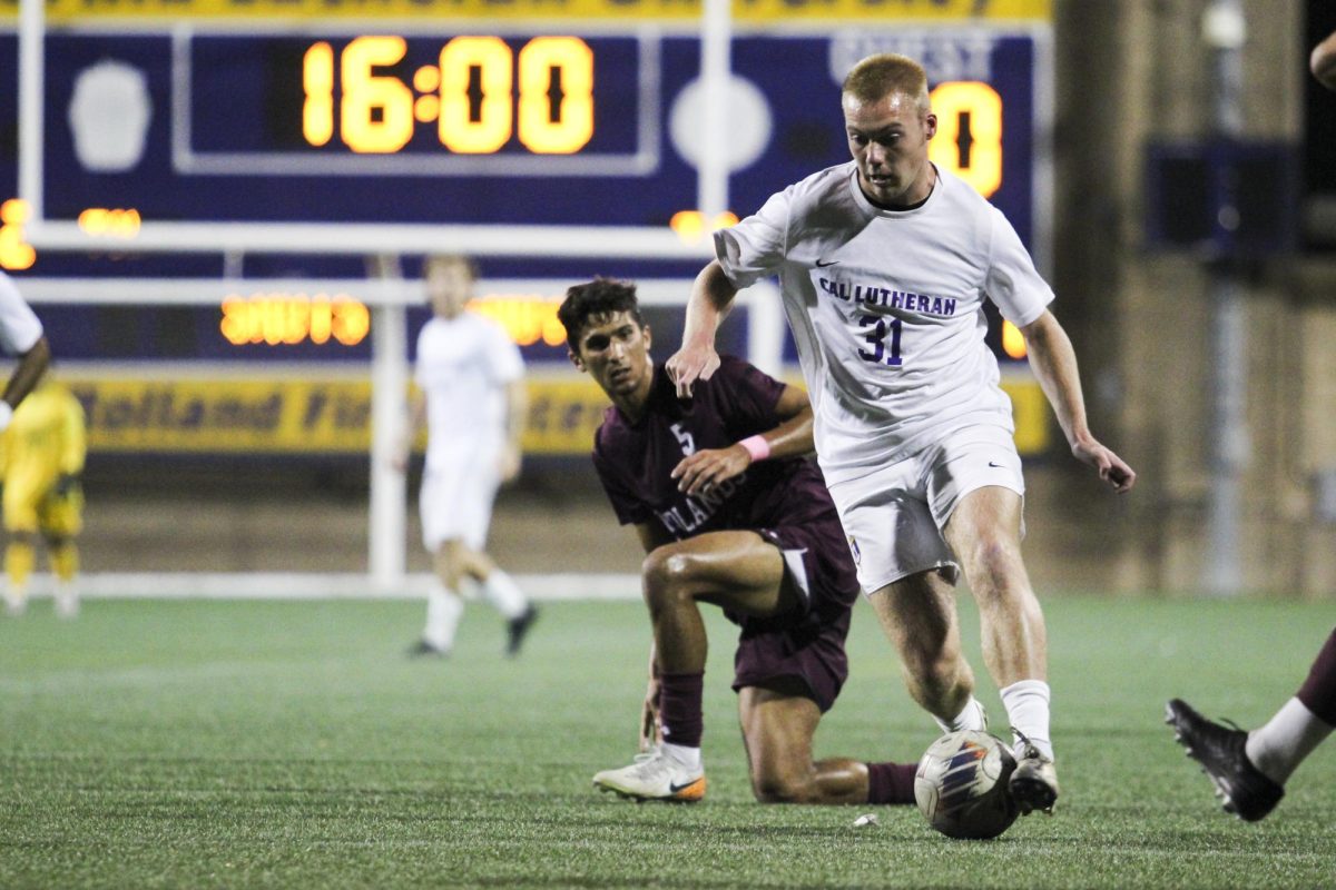 Forward Joel Wollin keeping the ball away from Redlands defender during Saturday’s action at William Rolland Stadium.