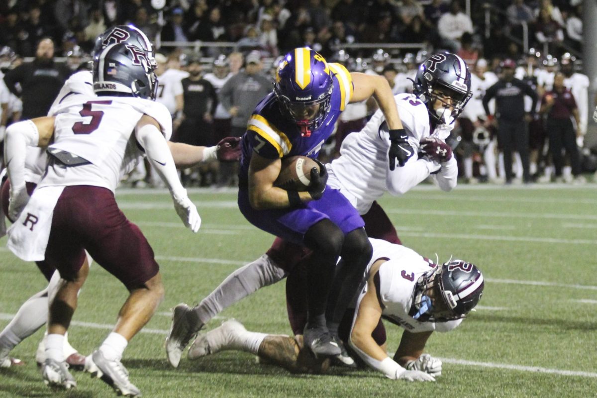 Junior wide receiver Taylor Evans dodges at tackle during Saturday's game.