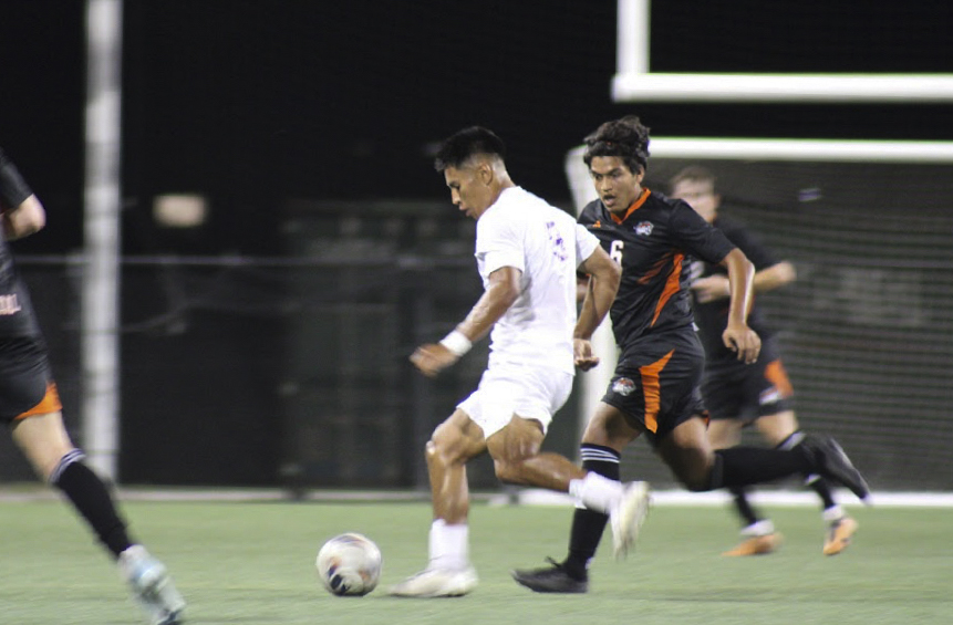 Senior midfielder JP Melgoza passing the ball to his teammate.