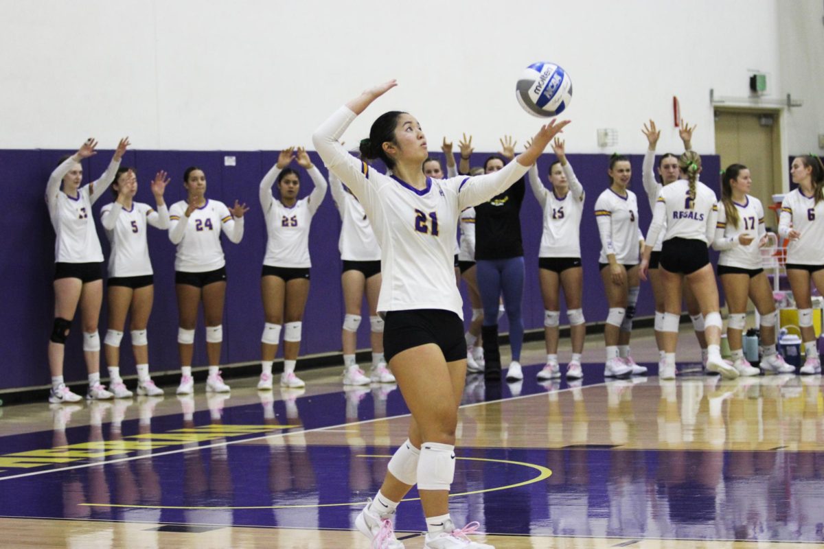 Makenna Kawamura serving the ball. 