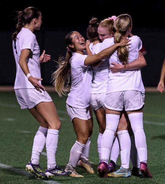 Regals Soccer players Avery West, Ryan Kaneko, Anna Evenson, Macey Peery, and Olivia Suarez celebrate a goal.