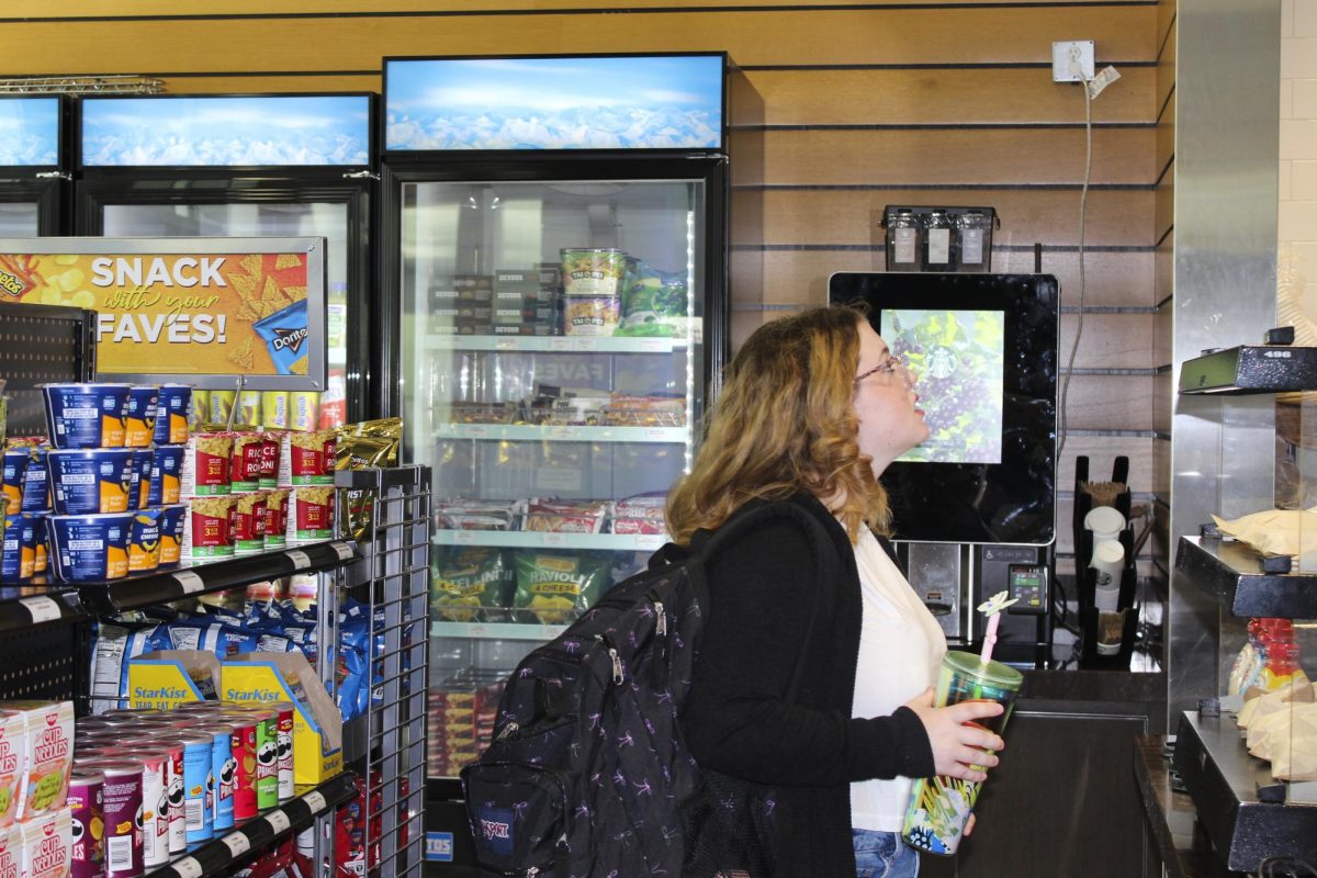 Student browses some of the new selections at the Ullman To Go market.