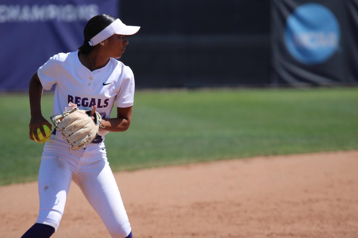 Sophomore infielder Sofia Aviles looks toward first base to throw out a runner.