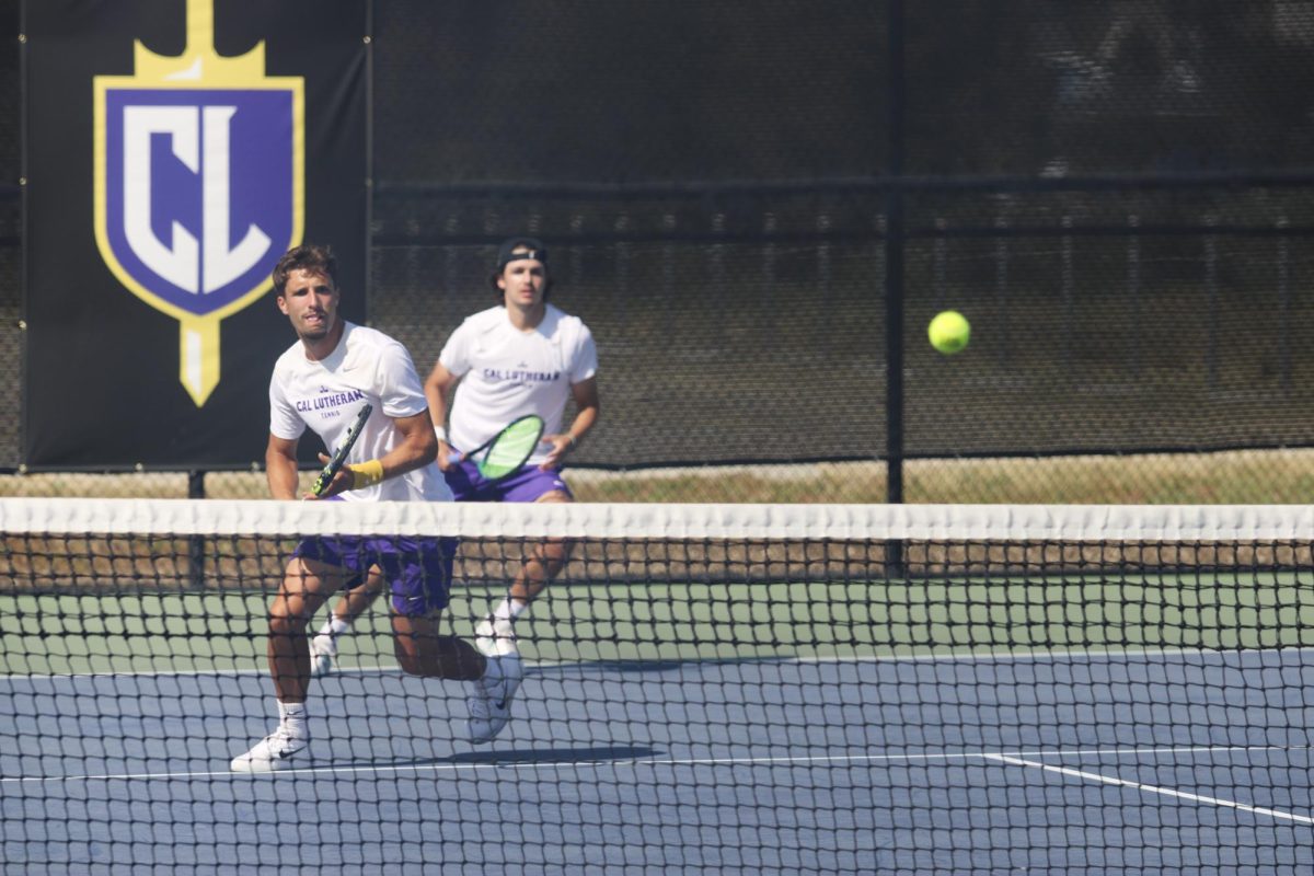 The successful doubles pairing of first-year Maxence Faniel, front, and senior Ethan Sherwood, back, get in position to return the ball over the net.